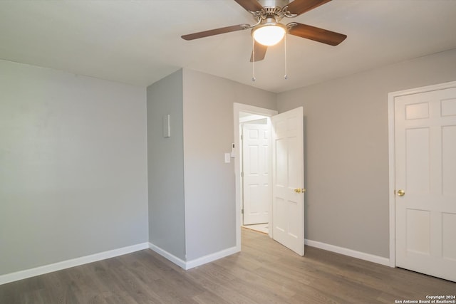 unfurnished bedroom with baseboards, a ceiling fan, and wood finished floors