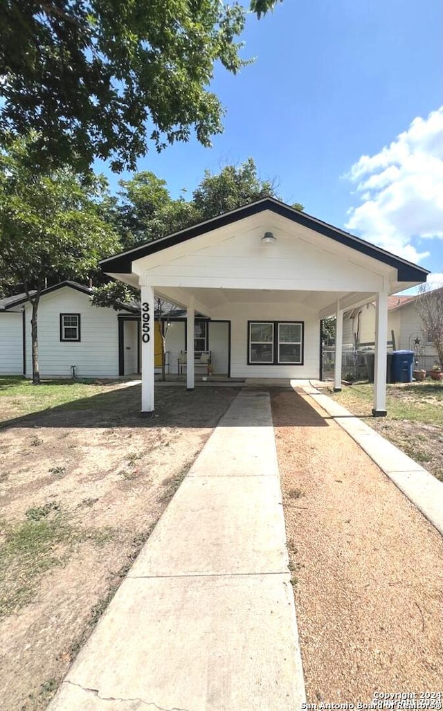 bungalow featuring driveway and a carport