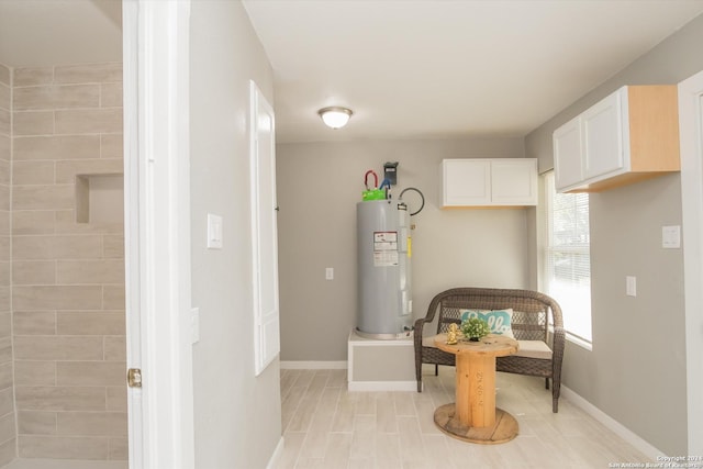 interior space with baseboards and electric water heater