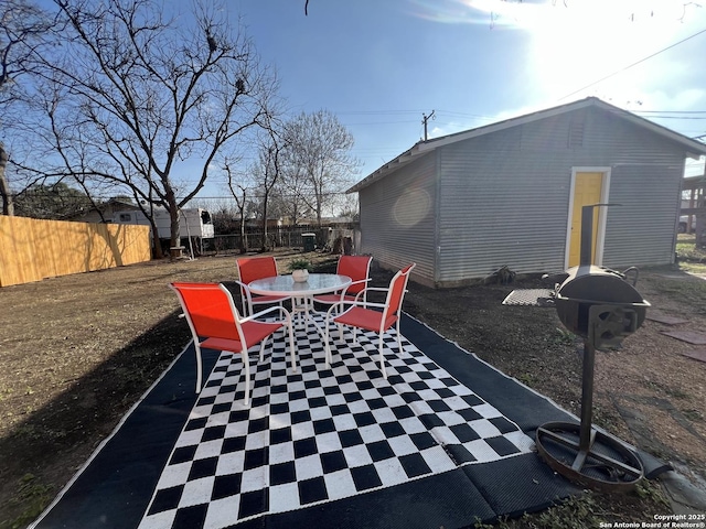 view of patio featuring fence and outdoor dining space