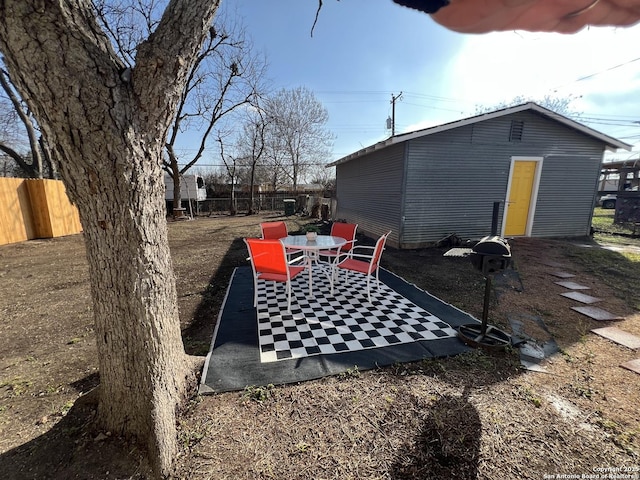 exterior space with fence and outdoor dining area