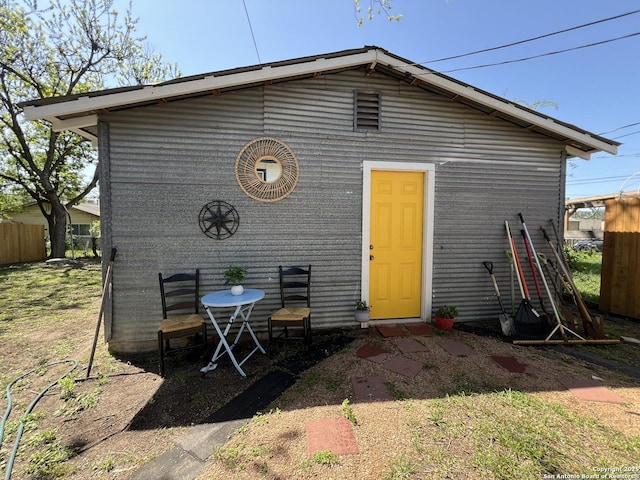 view of outbuilding featuring fence