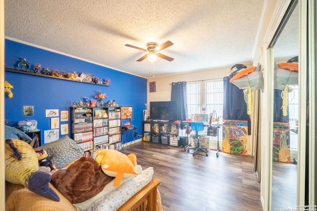 6405 Honey Hill, San Antonio, TX 78229 - rec room featuring crown molding, a ceiling fan, a textured ceiling, and wood finished floors