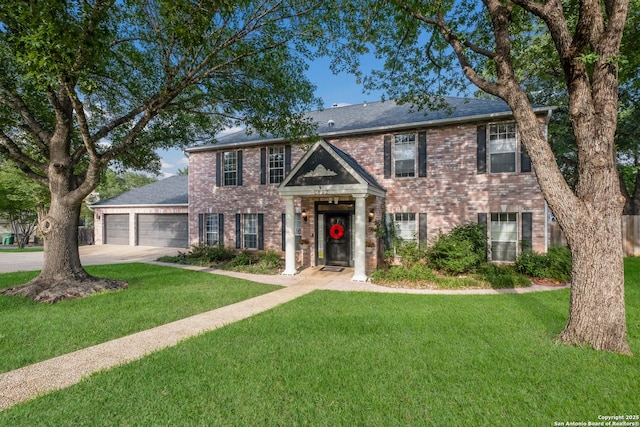 view of front of home with concrete driveway, brick siding, an attached garage, and a front lawn