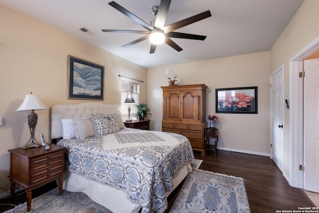 bedroom with baseboards, ceiling fan, dark wood-style floors, and visible vents