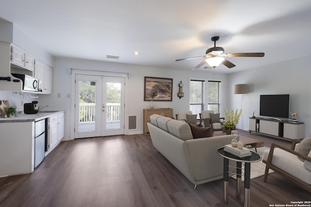 living room featuring french doors, a ceiling fan, a healthy amount of sunlight, and visible vents