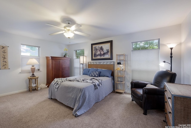 bedroom with baseboards, a ceiling fan, and carpet