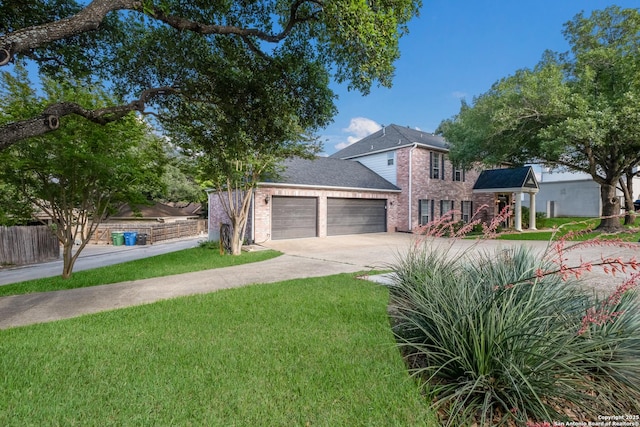 view of front facade featuring fence, an attached garage, a front lawn, brick siding, and concrete driveway