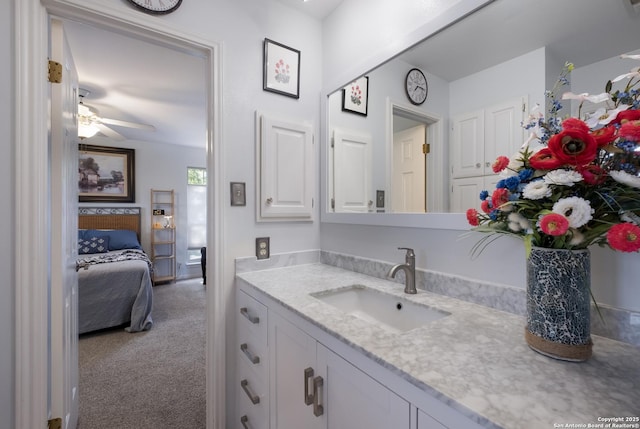ensuite bathroom featuring vanity, ensuite bathroom, and a ceiling fan