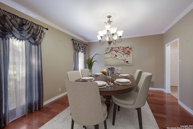 dining space with baseboards, an inviting chandelier, ornamental molding, and wood finished floors