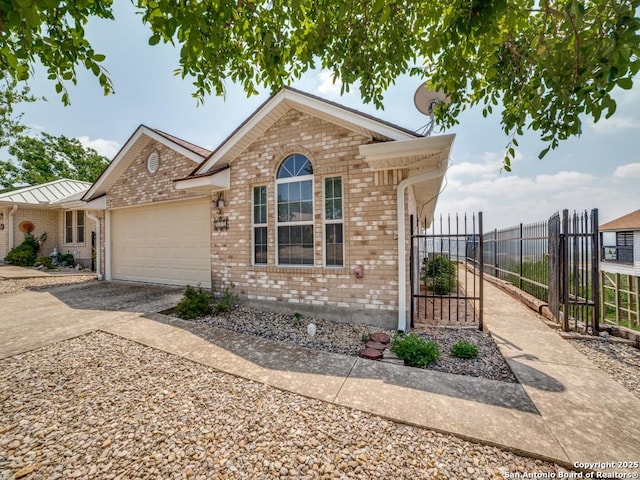 view of front of property featuring an attached garage, brick siding, fence, and aphalt driveway