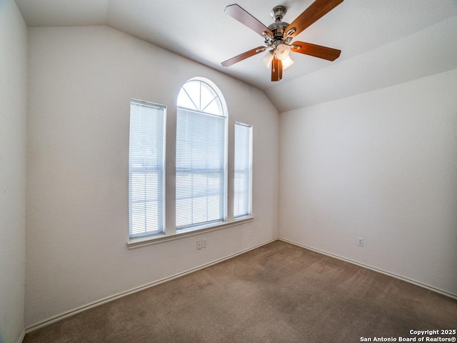 carpeted spare room with lofted ceiling and ceiling fan