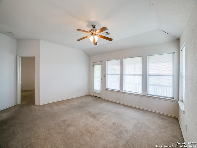 spare room featuring carpet, plenty of natural light, and a ceiling fan