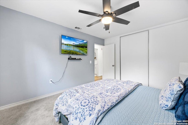 7722 Strolling Ln, Live Oak, TX 78233 - bedroom featuring visible vents, a closet, baseboards, ceiling fan, and light colored carpet