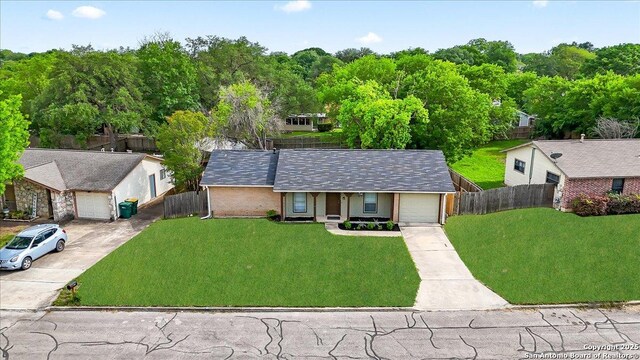 7722 Strolling Ln, Live Oak, TX 78233 - view of front of home with fence, covered porch, driveway, and a front yard