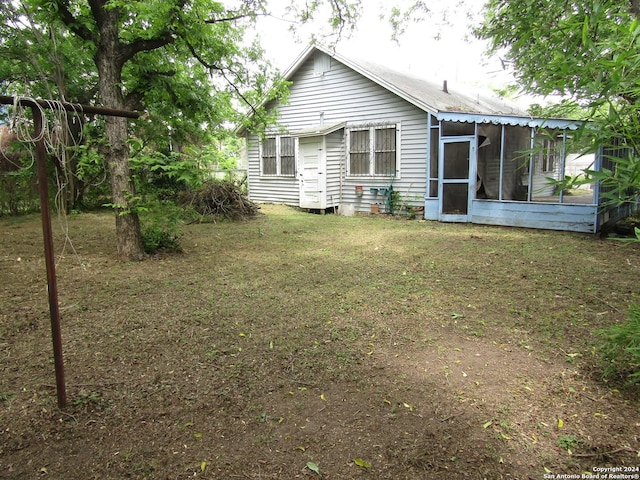 217 Lancaster, San Antonio, TX 78214 - rear view of property with a sunroom and a lawn