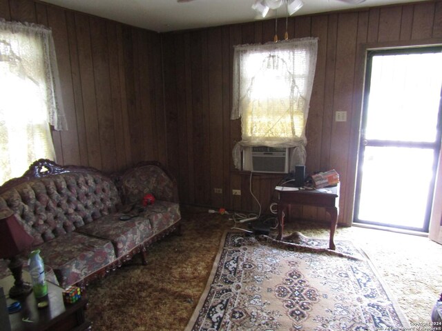 217 Lancaster, San Antonio, TX 78214 - living area featuring ceiling fan, wood walls, carpet, and cooling unit