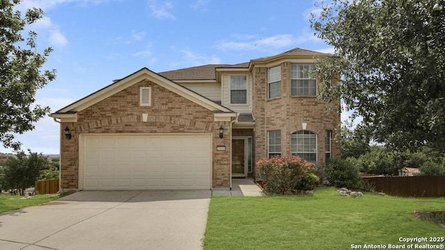 traditional-style house featuring brick siding, fence, driveway, and a front yard
