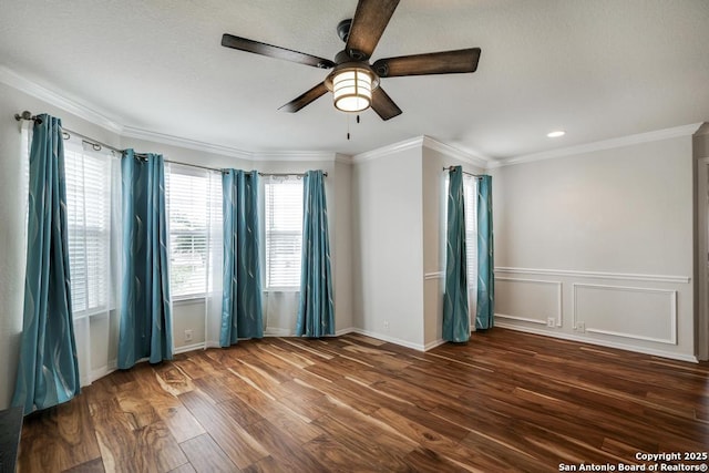 empty room with crown molding, baseboards, ceiling fan, and wood finished floors