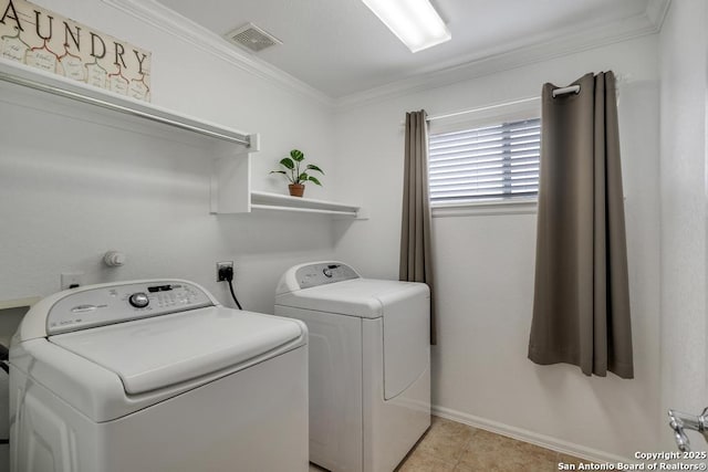 washroom with laundry area, ornamental molding, visible vents, washer and dryer, and baseboards