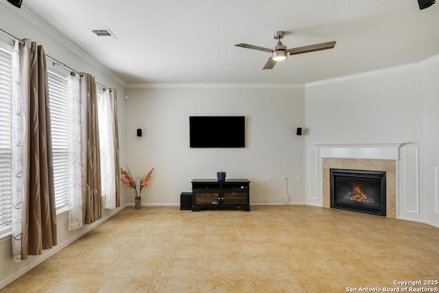 living area with crown molding, ceiling fan, and a wealth of natural light