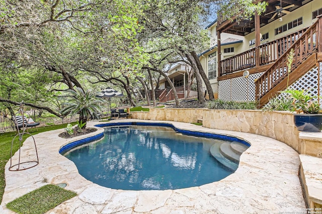 pool featuring fence and a patio area