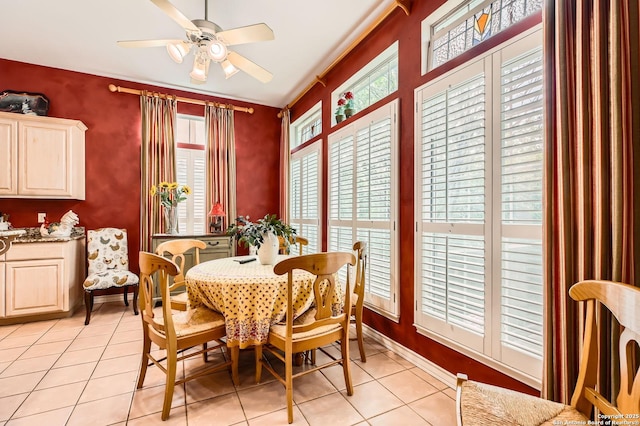dining space featuring ceiling fan and light tile patterned floors