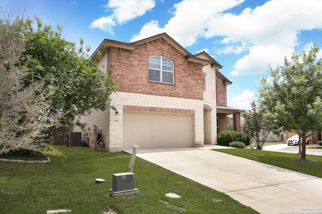 traditional home with an attached garage, driveway, brick siding, and a front yard