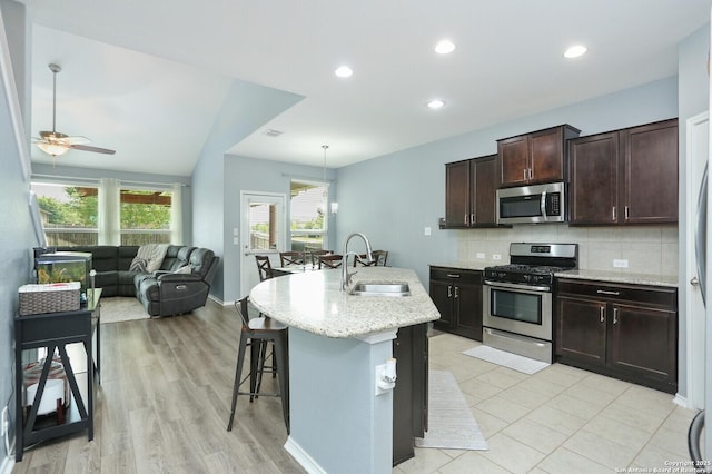 606 Sage Thrasher, San Antonio, TX 78253 - kitchen with decorative backsplash, a ceiling fan, dark brown cabinetry, a sink, and stainless steel appliances