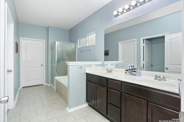 bathroom featuring a sink, double vanity, tile patterned floors, a bathtub, and an enclosed shower