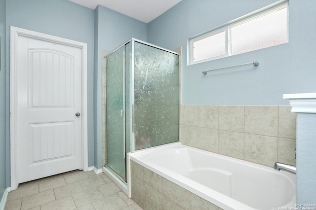 full bathroom with tile patterned flooring, a shower stall, and a garden tub