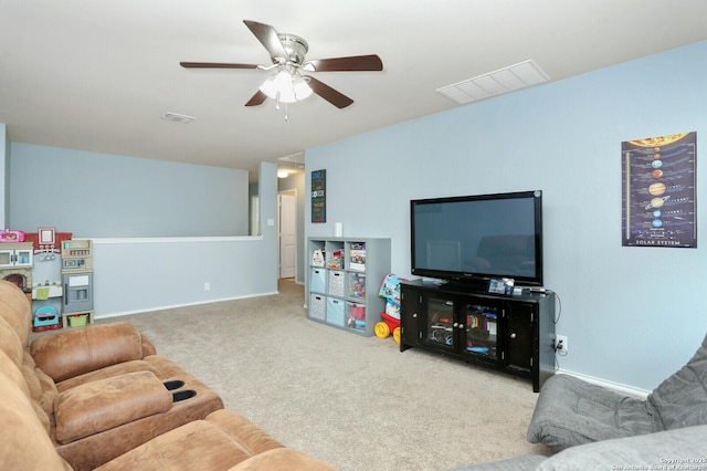 carpeted living room featuring visible vents, baseboards, and ceiling fan