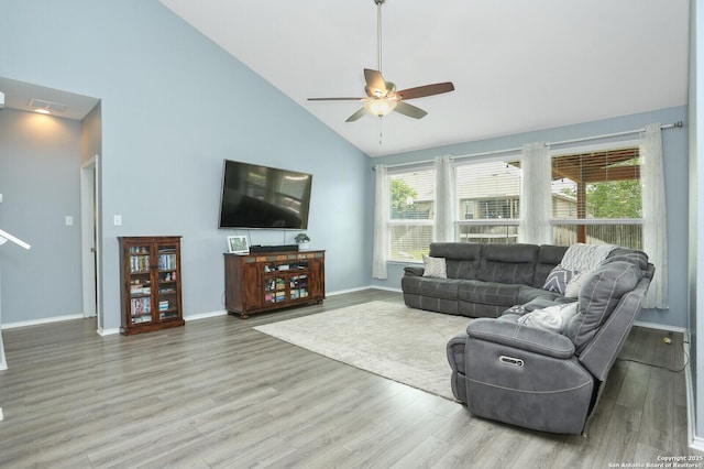 living area featuring plenty of natural light, high vaulted ceiling, ceiling fan, and wood finished floors