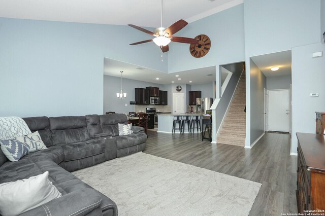 606 Sage Thrasher, San Antonio, TX 78253 - living room featuring ceiling fan, high vaulted ceiling, baseboards, wood finished floors, and stairway