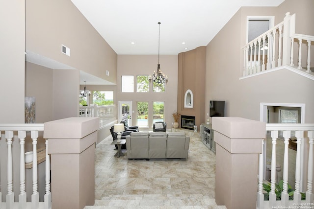2928 Hidden Elm, San Antonio, TX 78261 - living area with an inviting chandelier, a towering ceiling, visible vents, and a fireplace