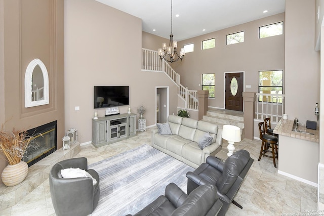 2928 Hidden Elm, San Antonio, TX 78261 - living area with baseboards, an inviting chandelier, a healthy amount of sunlight, and a towering ceiling