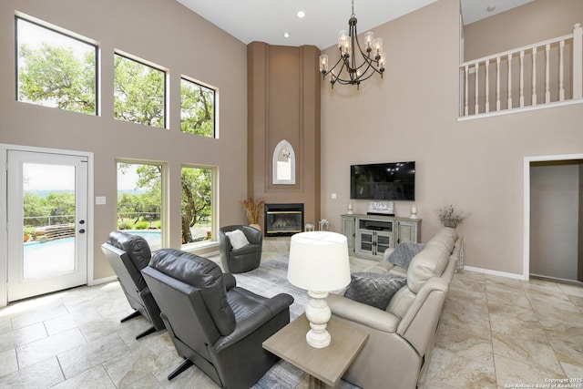2928 Hidden Elm, San Antonio, TX 78261 - living room featuring baseboards, a high ceiling, a fireplace, and a notable chandelier