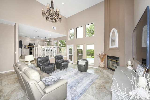 2928 Hidden Elm, San Antonio, TX 78261 - living area featuring a notable chandelier, a glass covered fireplace, baseboards, a towering ceiling, and visible vents