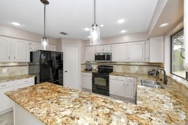 2928 Hidden Elm, San Antonio, TX 78261 - kitchen featuring a sink, backsplash, black appliances, and a textured ceiling