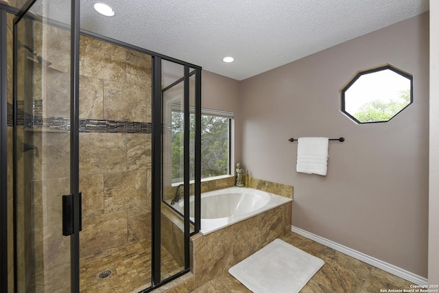 2928 Hidden Elm, San Antonio, TX 78261 - full bathroom featuring a textured ceiling, baseboards, a garden tub, and a stall shower