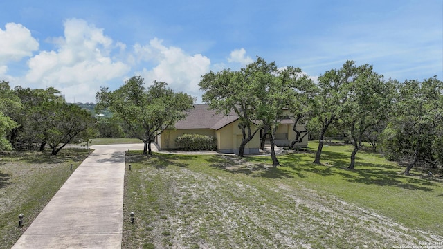 2928 Hidden Elm, San Antonio, TX 78261 - view of front of home featuring stucco siding, concrete driveway, and a front yard
