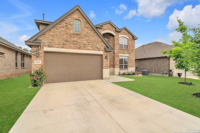 traditional home featuring concrete driveway, brick siding, central AC unit, and a front yard
