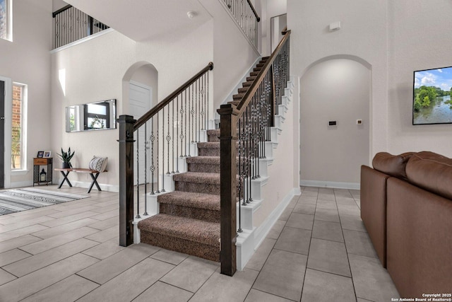 stairs with arched walkways and a towering ceiling