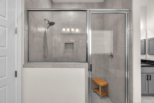 bathroom featuring vanity and a shower stall