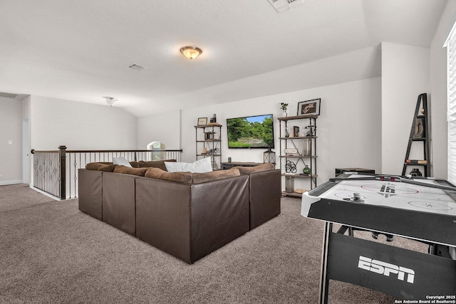 carpeted living room with visible vents and vaulted ceiling