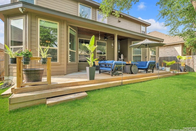 rear view of house featuring outdoor lounge area, fence, a deck, a ceiling fan, and a yard