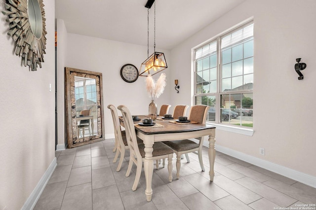 dining room featuring baseboards, a chandelier, and a wealth of natural light
