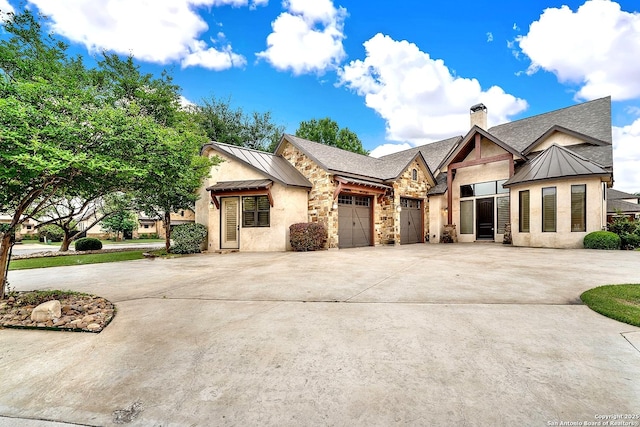 view of front of property with a standing seam roof, metal roof, and driveway