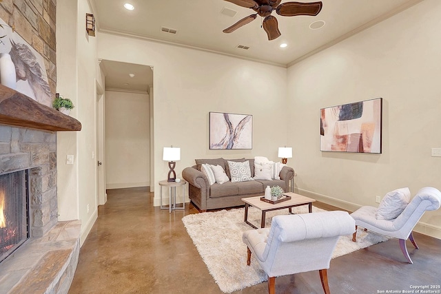 living area featuring baseboards, ornamental molding, concrete floors, and a ceiling fan