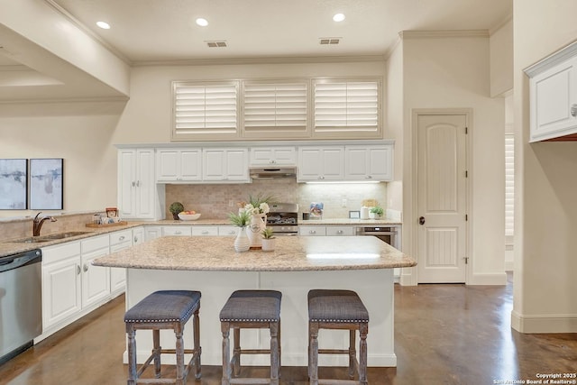 kitchen featuring visible vents, finished concrete flooring, a sink, appliances with stainless steel finishes, and backsplash